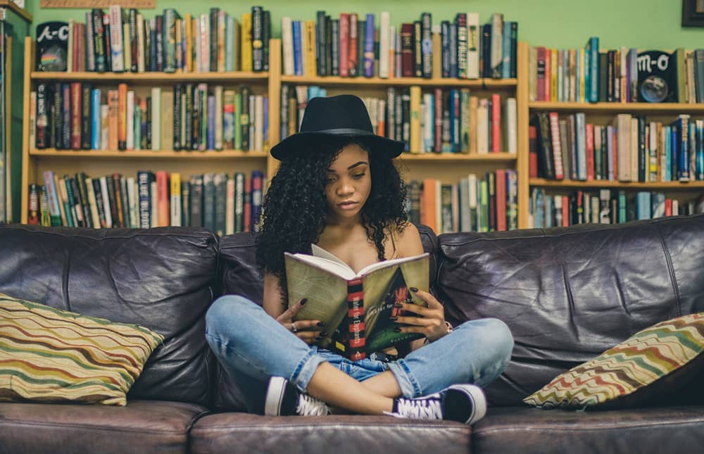 Good reads, girl on sofa reading a book