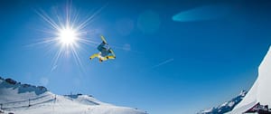 Where in the World 654 snowboarder against blue sky and snow scene big air